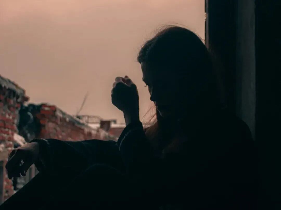 a man sitting in a window