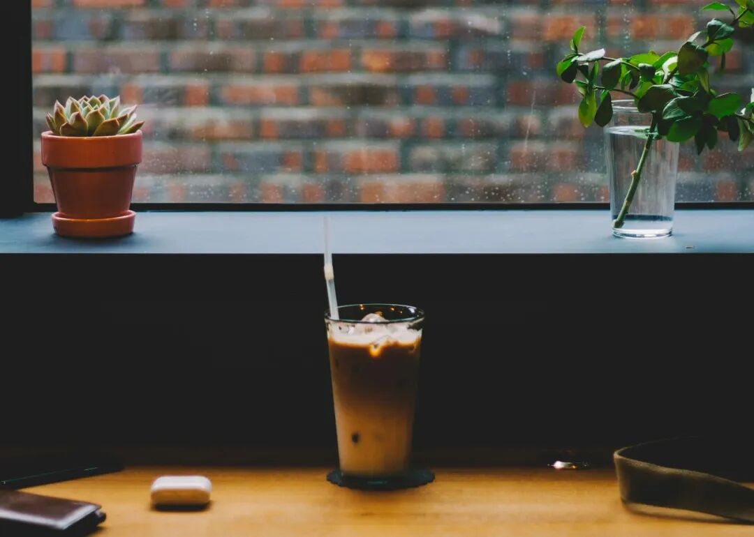 clear drinking glass beside wall