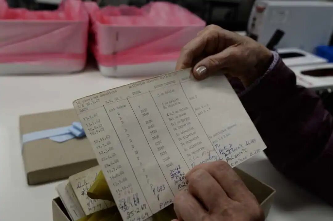 Harrison holds an index card documenting his blood donations in the 1960s.