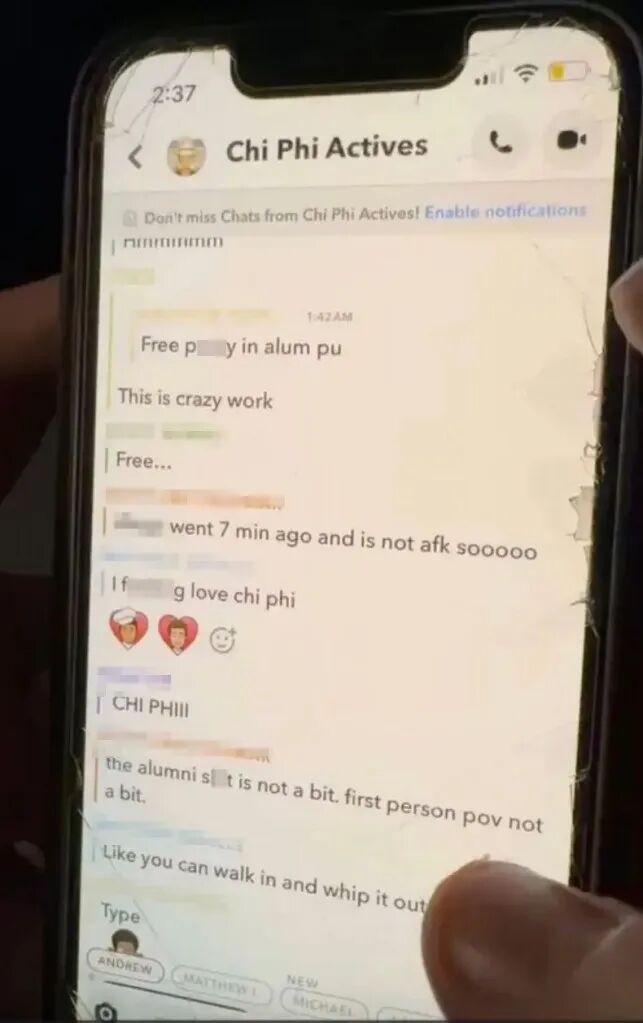 A close-up of a cracked phone screen showing a chat titled "Chi Phi Actives" with messages containing explicit content.