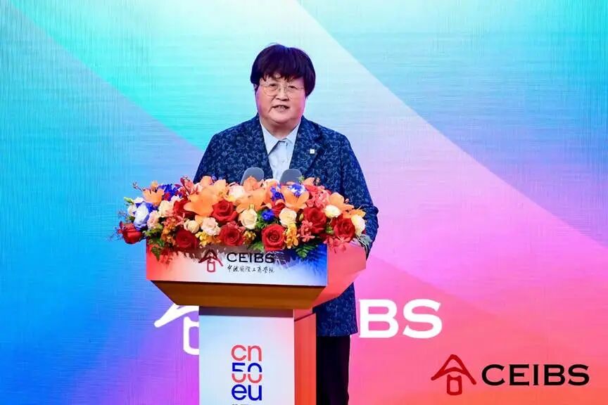 A person standing at a podium with flowers AI-generated content may be incorrect.