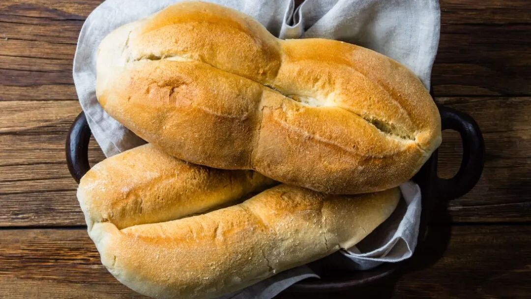 Marraqueta, Chile. Split into four lobes, the marraqueta has a pale, fluffy interior and a crispy exterior.