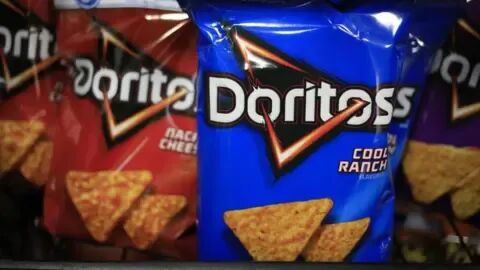 Getty Images A file image of a blue packet of cool ranch Doritos. In the background is a red packet of nacho cheese flavoured Doritos