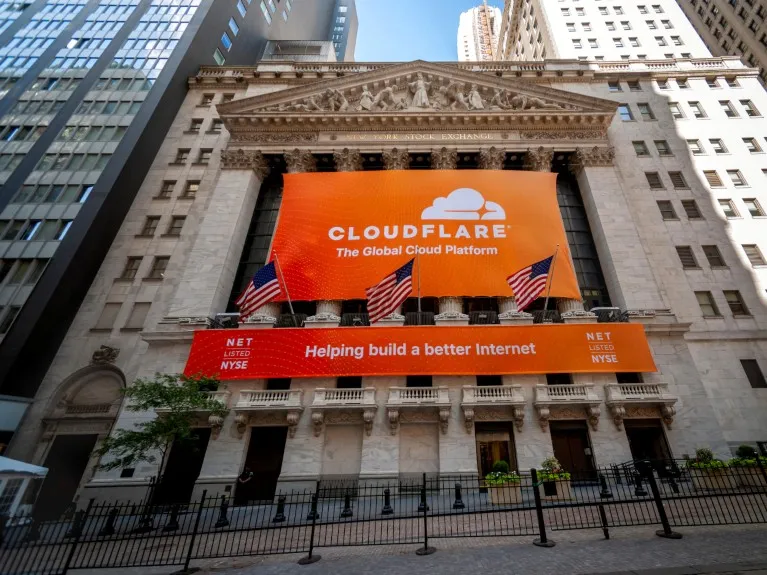 The New York Stock Exchange in 2019, decorated with a bright orange banner for the Cloudflare initial public offering.