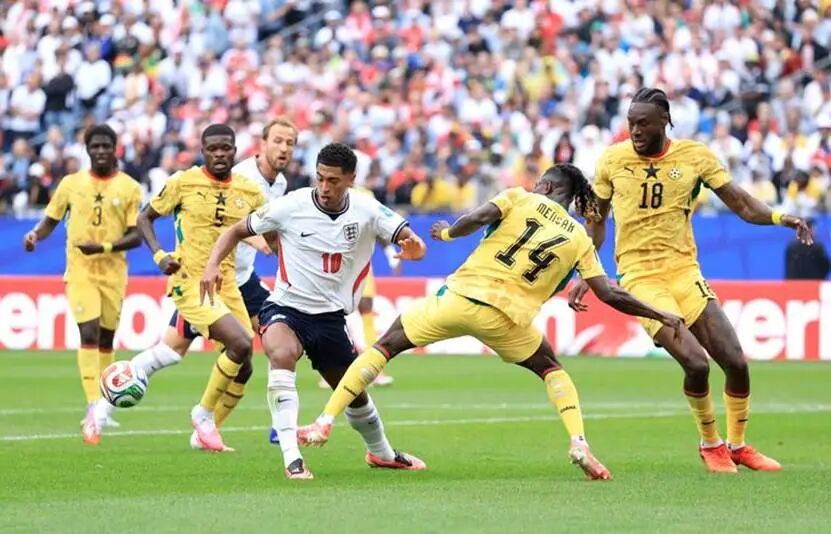 FOXBOROUGH, MASSACHUSETTS - JUNE 23: Jude Bellingham #10 of England is challenged by Gideon Mensah #14 of Ghana during the FIFA World Cup 2026 Group L match between England and Ghana at Boston Stadium on June 23, 2026 in Foxborough, Massachusetts. (Photo by Buda Mendes/Getty Images)