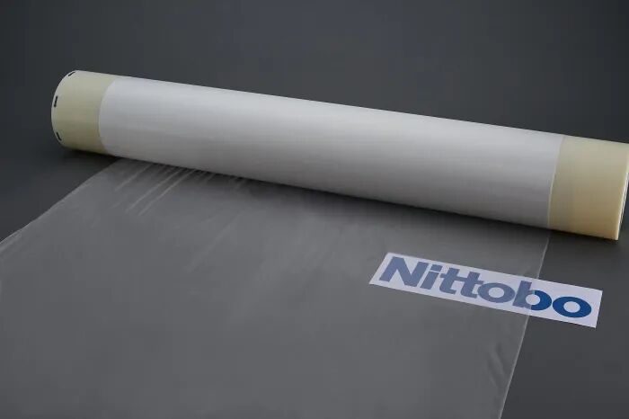 A roll of translucent glass fiber material with the Nittobo logo near it.