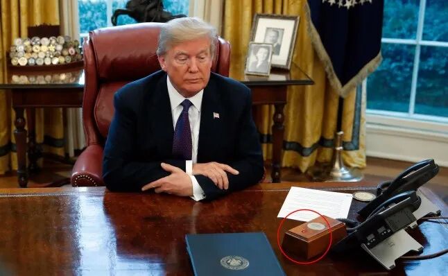 ***Diet Coke button circled*** President Donald Trump sits at the Resolute Desk after signing Section 201 actions in the Oval Office of the White House in Washington, Tuesday, Jan. 23, 2018. (AP Photo/Carolyn Kaster)