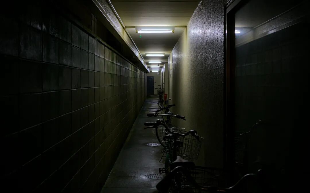 A long hallway with bikes parked on the side of it
