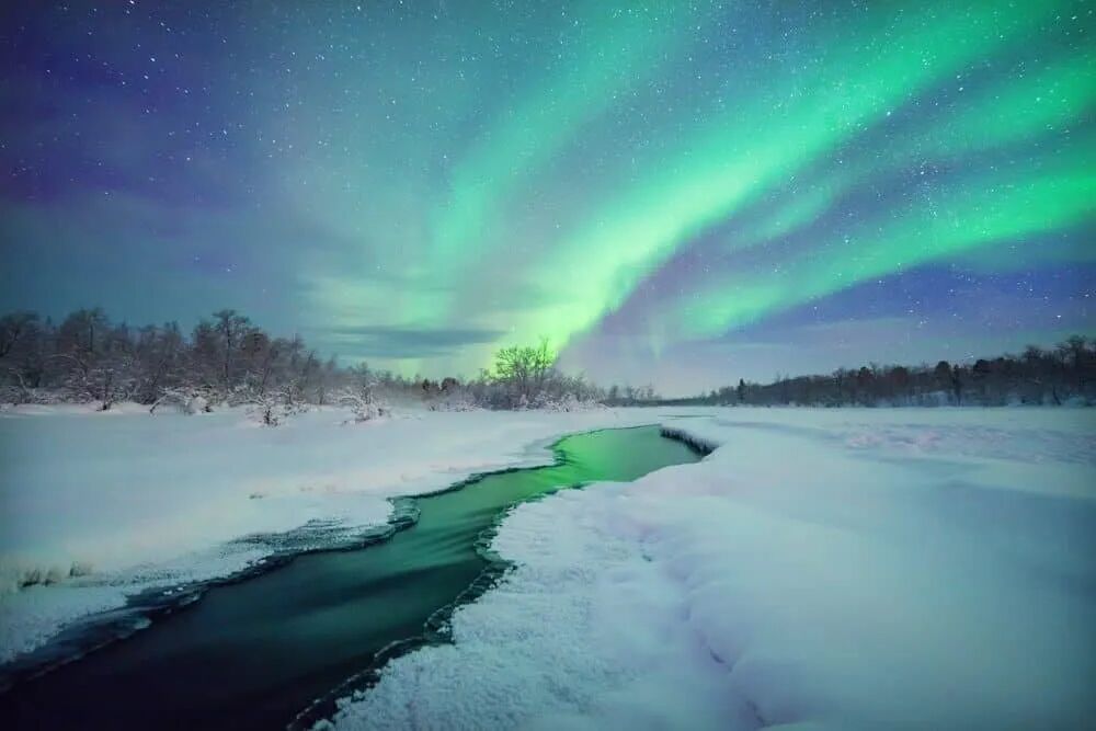 Aurora Borealis over snowy river